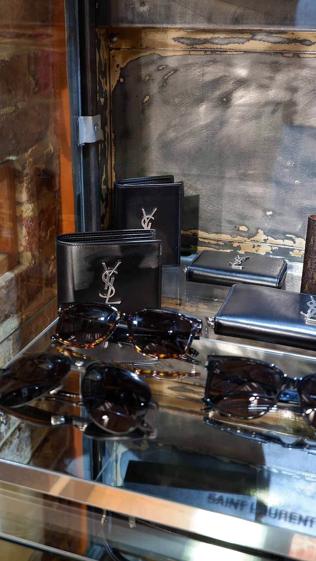 Zoo Fashions. Brick-and-mortar mens designer clothing store in Ilford Essex. Store Interior. Stockist of designer brands including Saint Laurent, ranging from ready-to-wear to accessories like Sunglasses SL599 and Cassandre Wallets