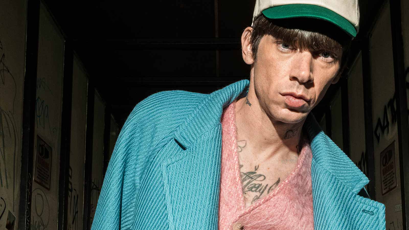 Kenzo clothing. A preppy uptown man, whose silhouette is imbued with modernity and sophistication, pushing boundaries between statement and elegance.