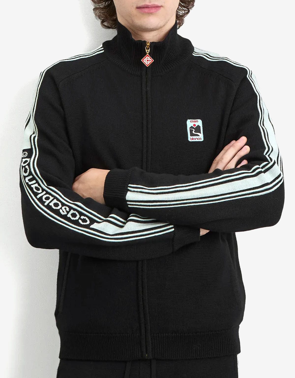 Casablanca Black Merino Wool Track Jacket MPF25-KW-1003-01. Black tracksuit with stripes on sleeves, and a logo on the chest