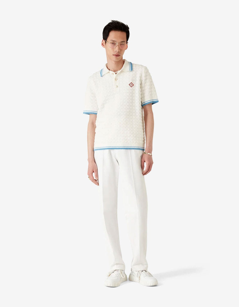 Casablanca White Cotton Boucle Polo Shirt MPF25-KW-999-01. Model wearing a white textured polo shirt with blue accents 