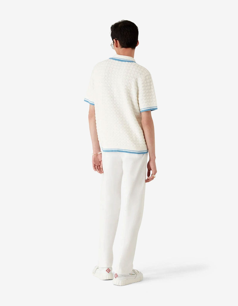 Casablanca White Cotton Boucle Polo Shirt MPF25-KW-999-01. Model wearing a white textured polo shirt with blue accents 