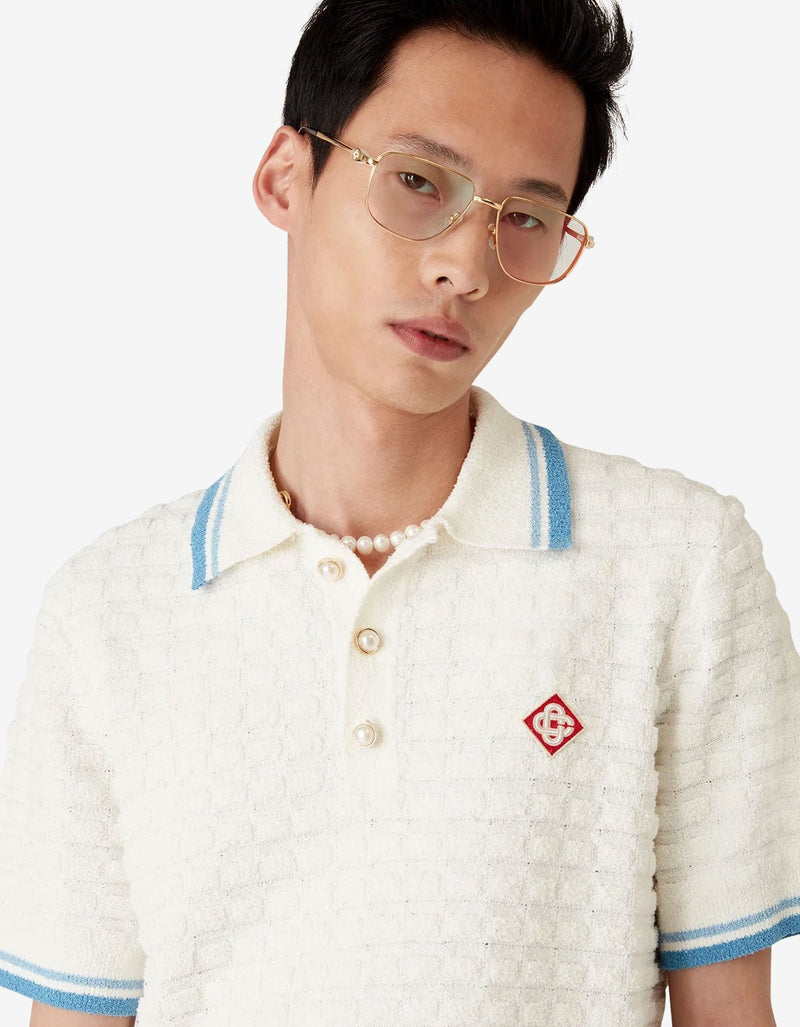 Casablanca White Cotton Boucle Polo Shirt MPF25-KW-999-01. Model wearing a white textured polo shirt with blue accents 