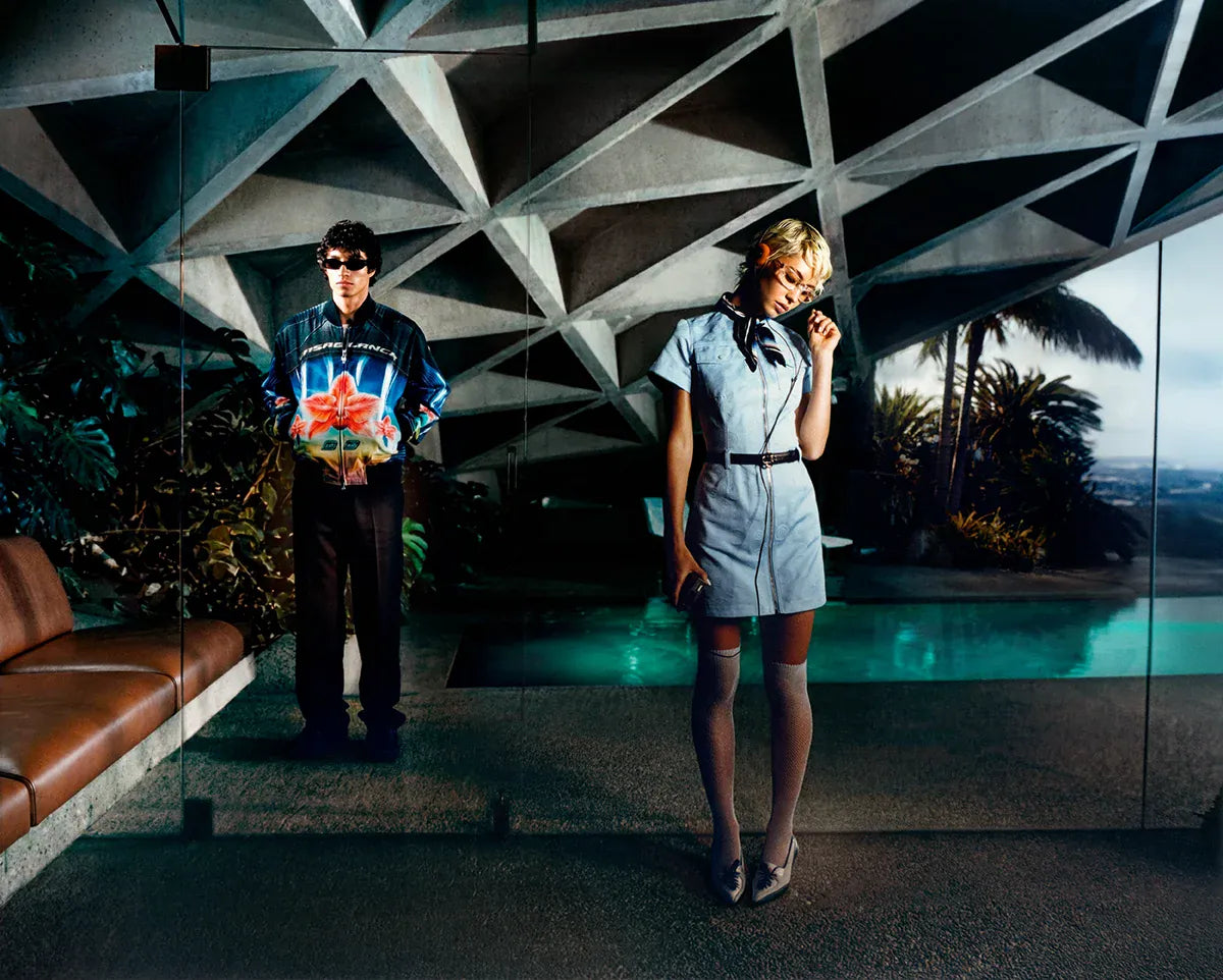 Casablanca SS26. Two people standing in a modern architectural setting with geometric ceiling design.
