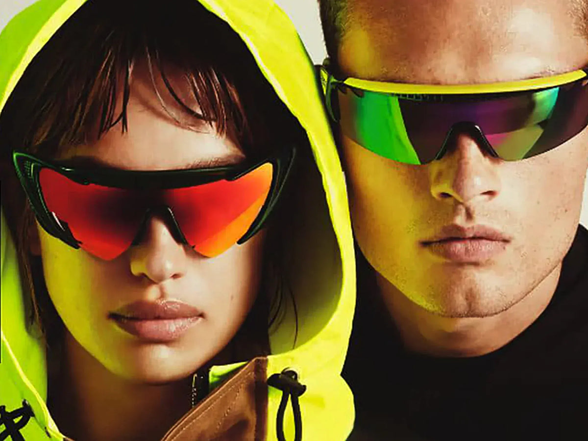 DSquared2 clothing for men. Two people wearing colorful sunglasses with a neutral background