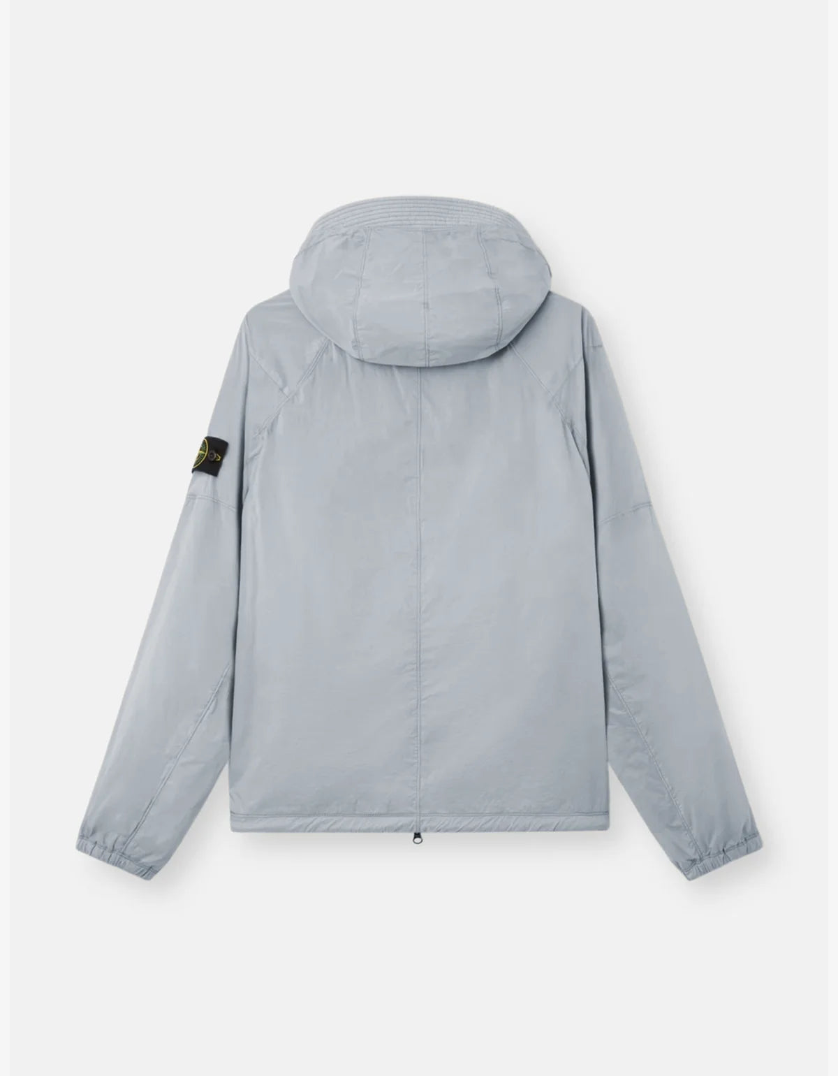 A light gray hooded jacket shown from the back, featuring a small black and yellow compass badge on the left sleeve, set against a plain light gray background.
