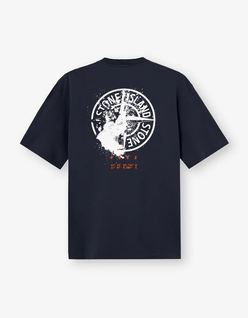 A dark navy blue short-sleeve t-shirt shown from the back, featuring a large distressed white circular Stone Island graphic with a shark motif and small orange text below.