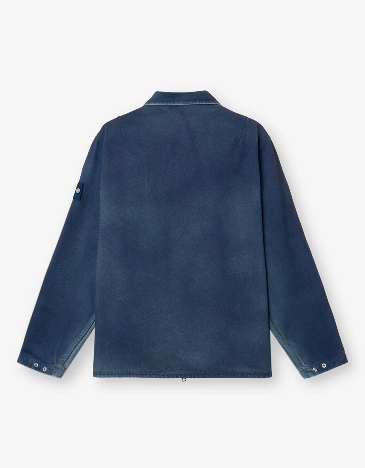 A dark blue denim jacket shown from the back, featuring a classic collar and buttoned cuffs, laid flat against a light off-white background.