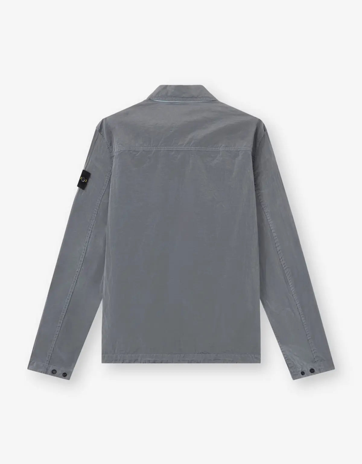 A gray long-sleeve utility shirt jacket shown from the back, featuring a collar, button cuffs, and a black fabric brand patch on the left sleeve, set against a plain light gray background.