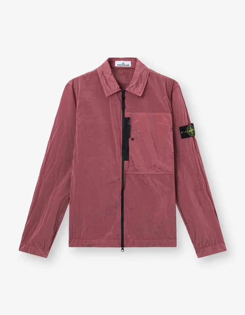 A Stone Island zip-up utility jacket in a dusty rose color, featuring the signature compass patch on the left sleeve, displayed against a clean white background.