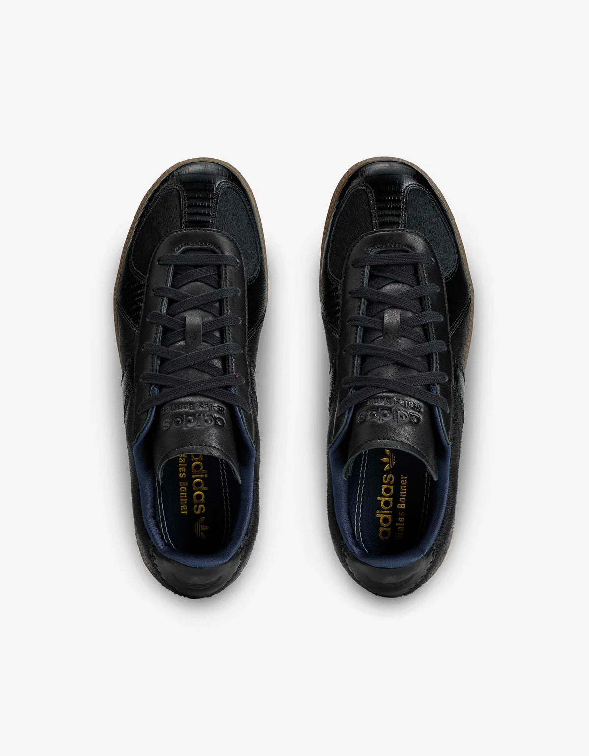 A pair of black Adidas Samba sneakers shown from a top-down view on a light gray background.