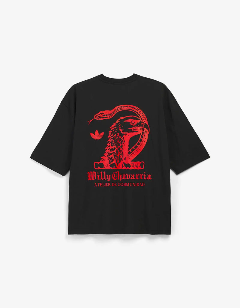 A black short-sleeve t-shirt with a red graphic print on the front, featuring a snake, a bird, and the text 'Willy Chavarria' and 'Atelier De Communidad'.